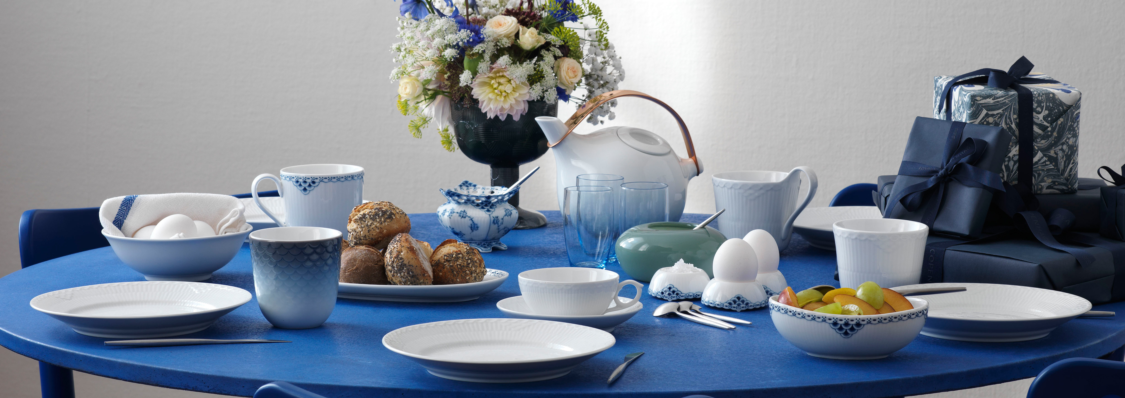 A table set with the classic White Fluted Half Lace Plates. A table set for a birthday breakfast with the family or close friends.